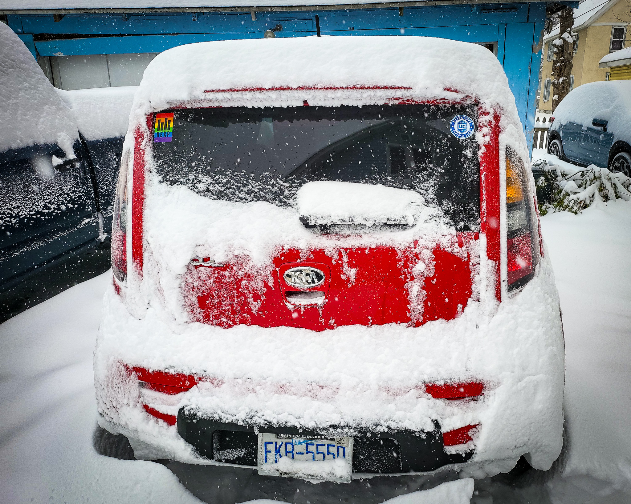 snow covered Roz (kia soul) with two stickers visible on the back hatch glass