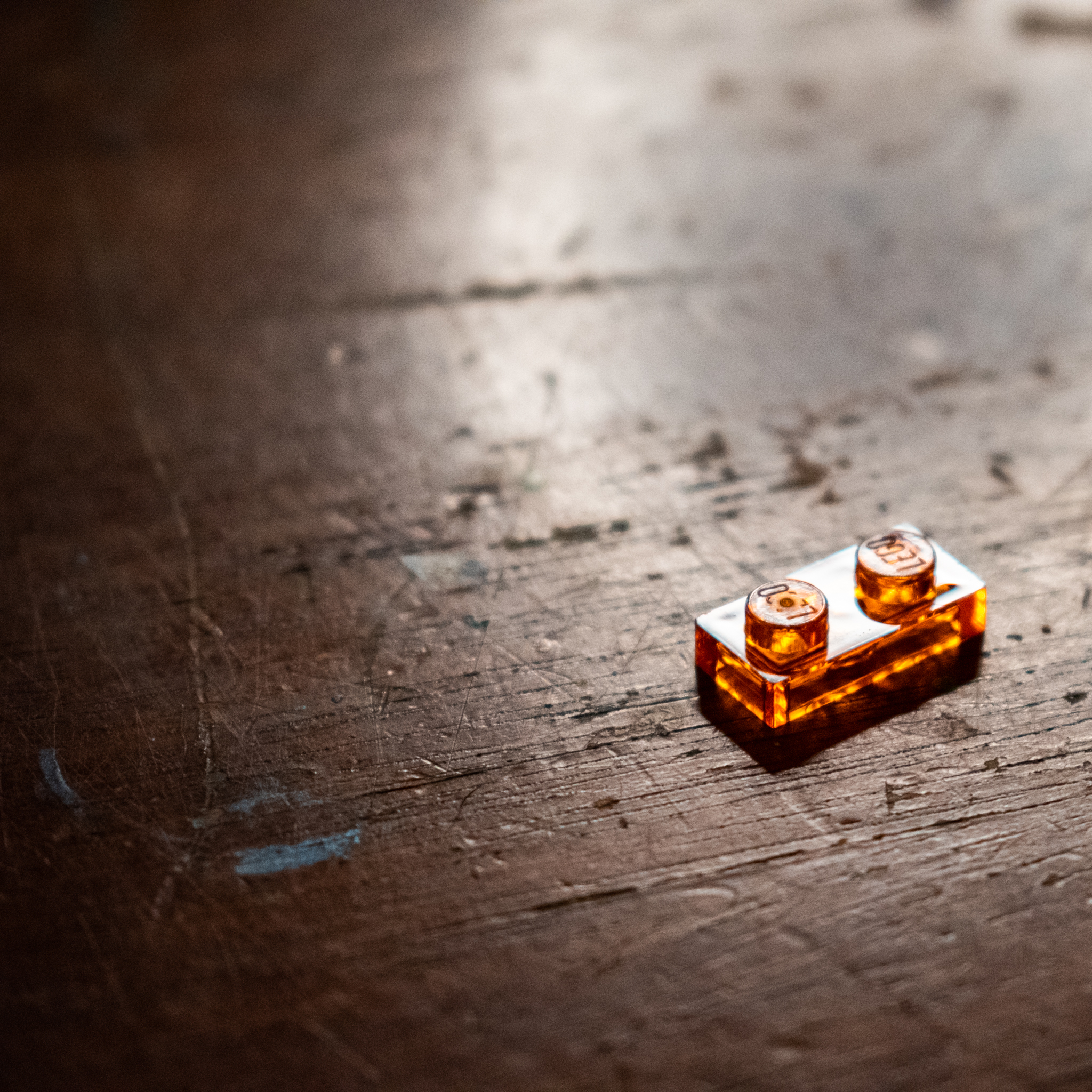 red lego two stud plate on wood table top