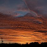 very vivid and dramatic sunset from across an empty parking lot