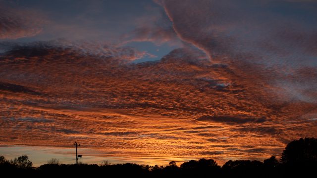 very vivid and dramatic sunset from across an empty parking lot